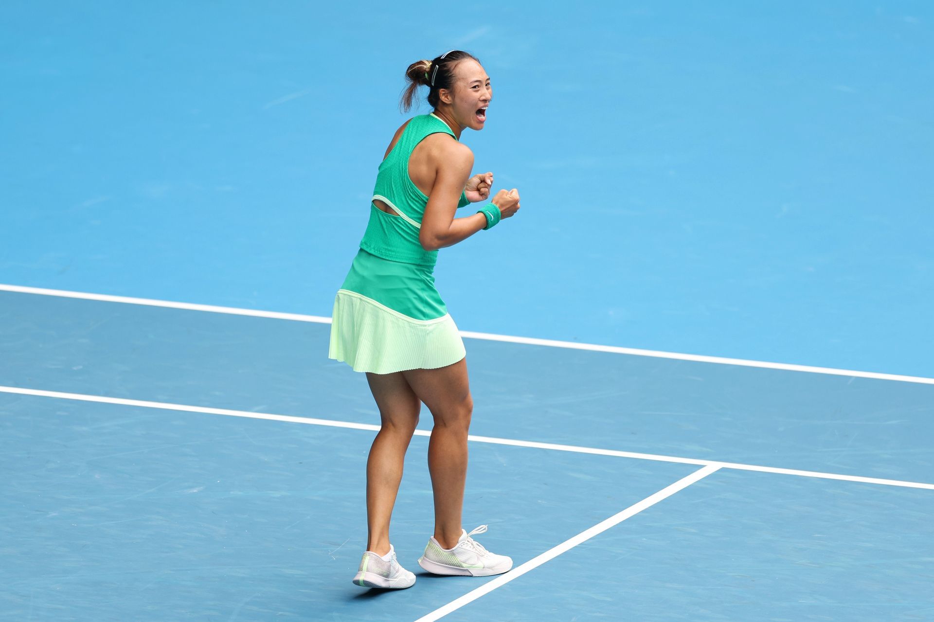 Zheng Qinwen celebrates match point against Yafan Wang