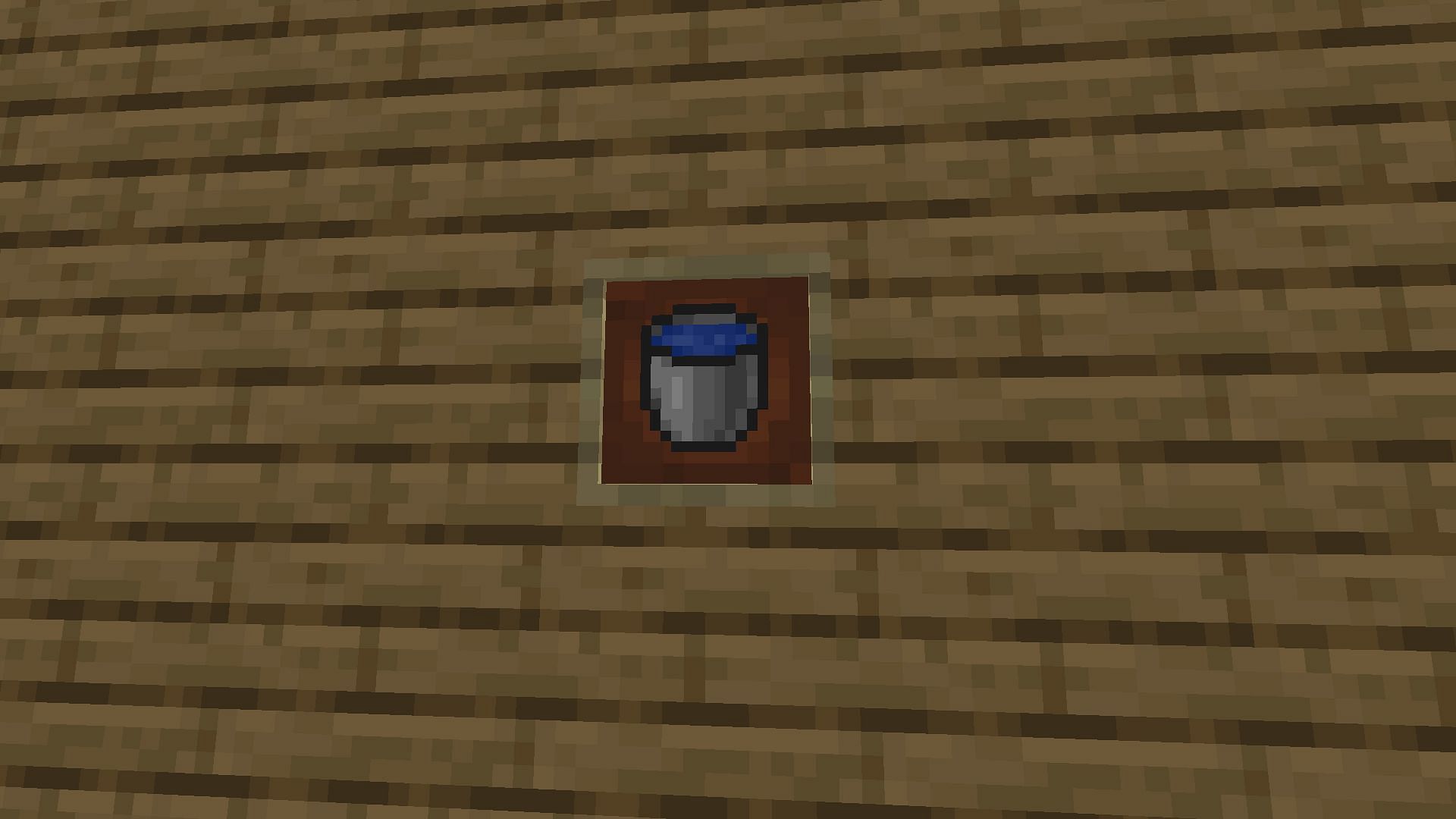 A water bucket held in an item frame in Minecraft.