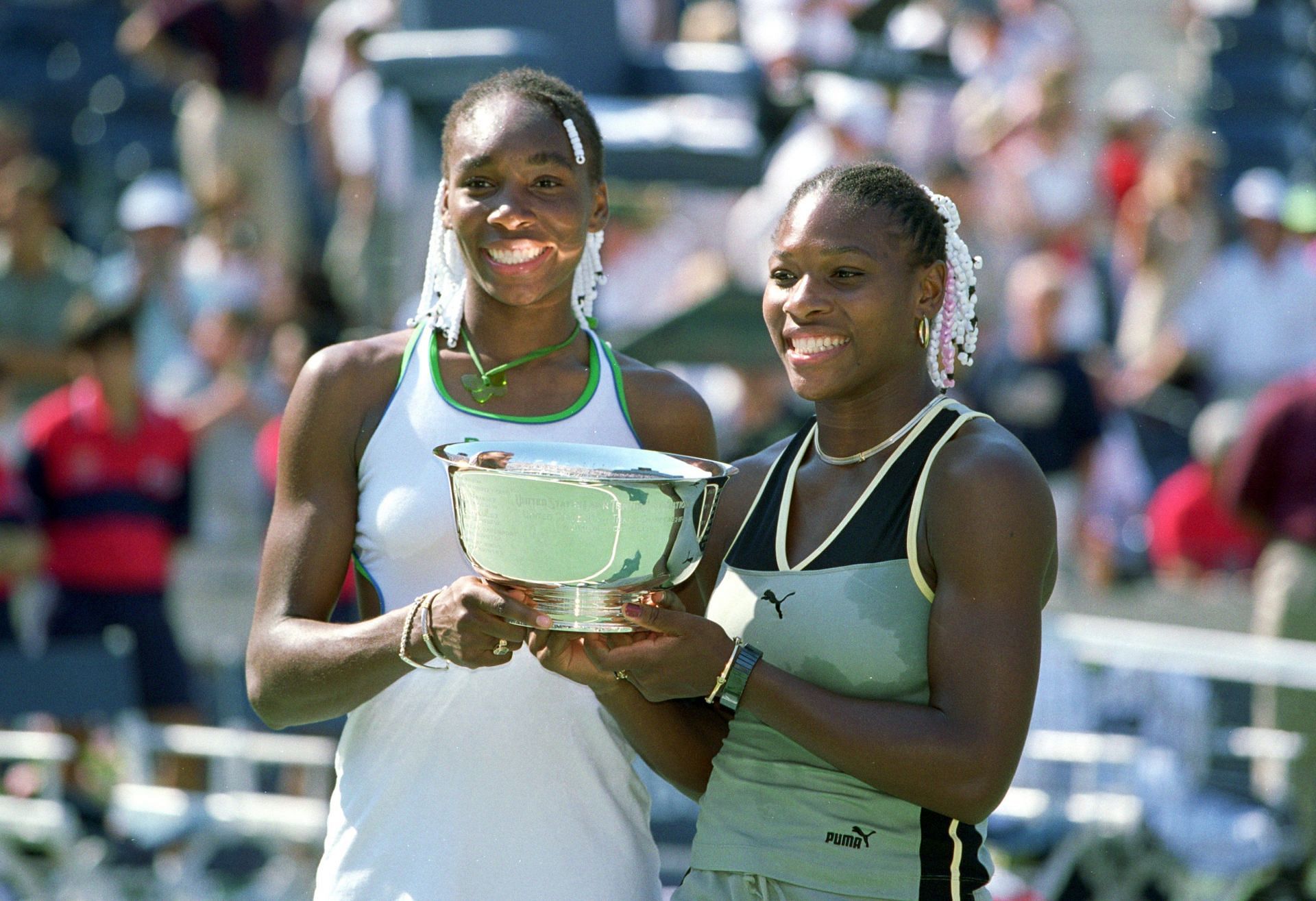 The Williams Sisters pictured at the 1999 US Open with their doubles trophy