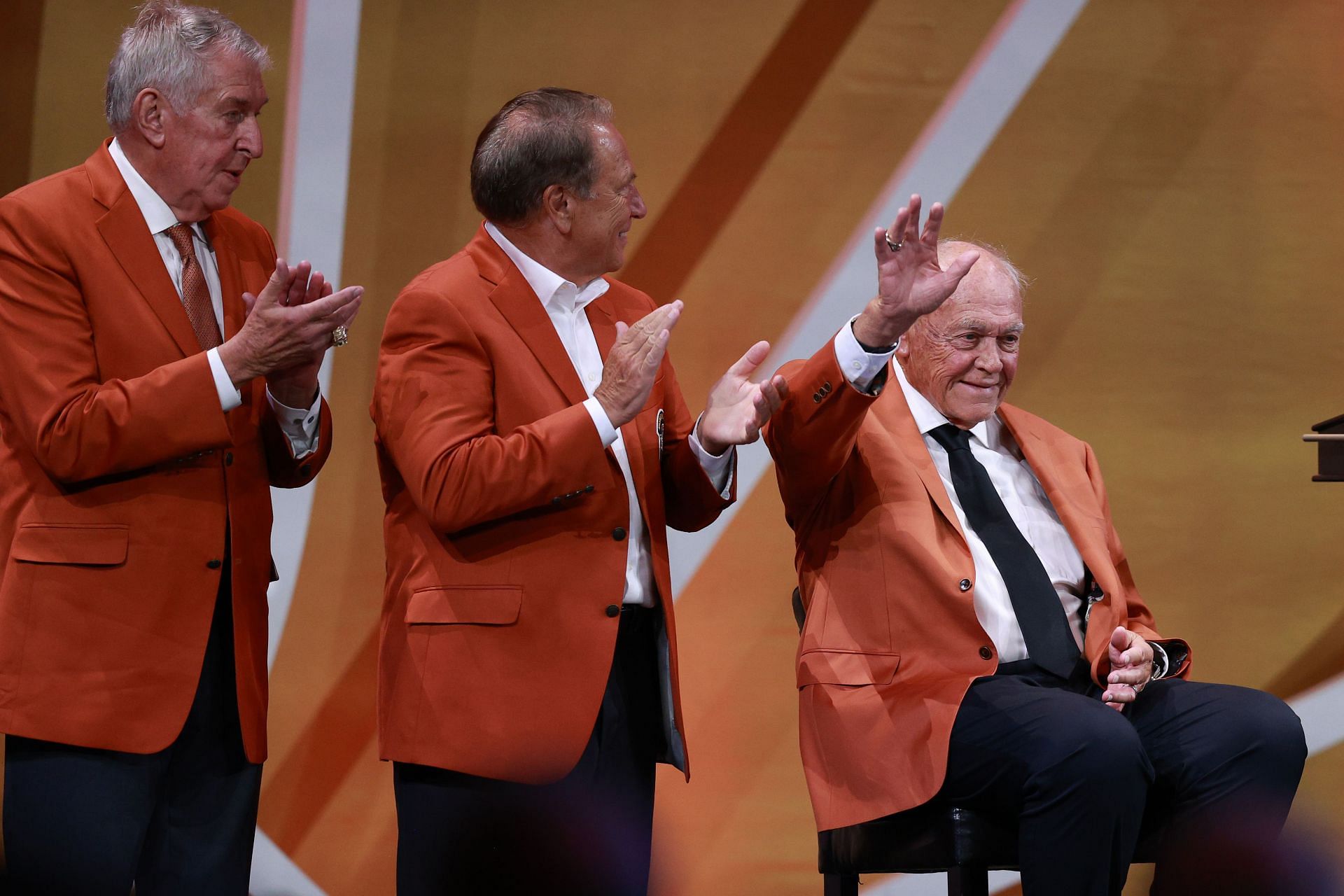 Purdue coach Gene Keady, waving on the right at the 2023 Basketball Hall of Fame Enshrinement Ceremony, recruited Painter to Purdue as a player and helped bring Painter back to replace him in 2005.