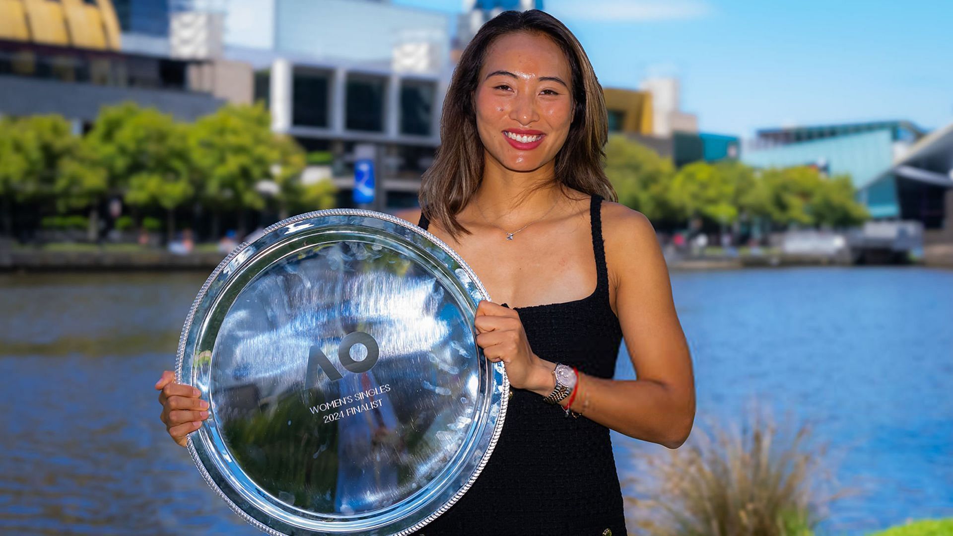 Zheng Qinwen poses with Australian Open runner -up trophy wearing Miu Miu Tweed dress