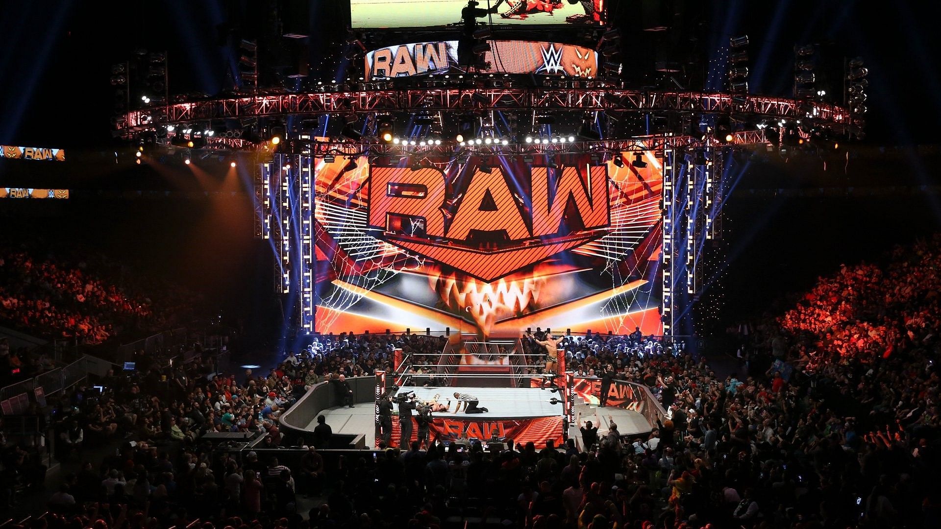 The WWE RAW ring and stage in an arena packed with fans