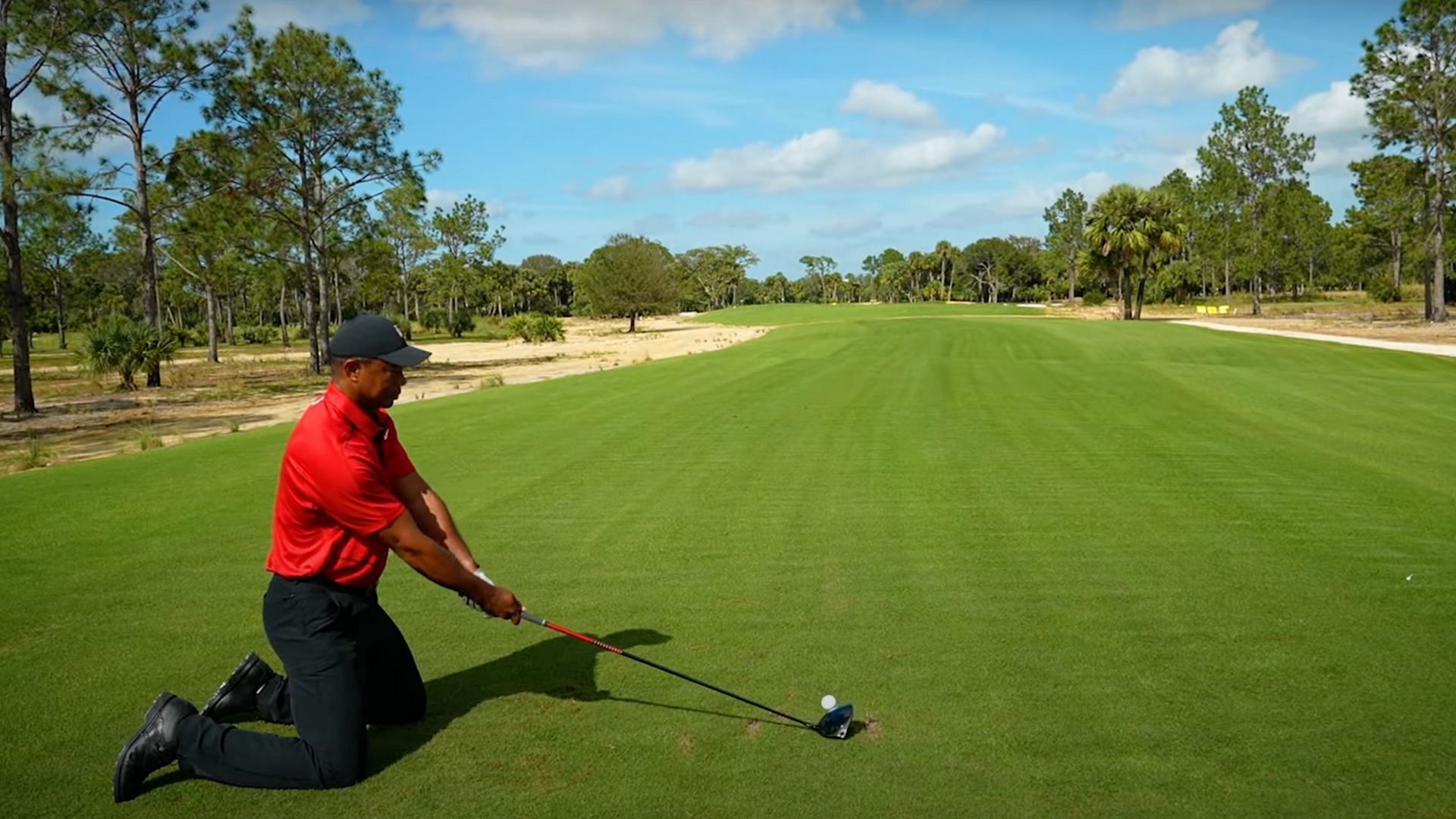 Tiger Woods lines up for a tee shot (Image via YouTube @/BarstoolSports)