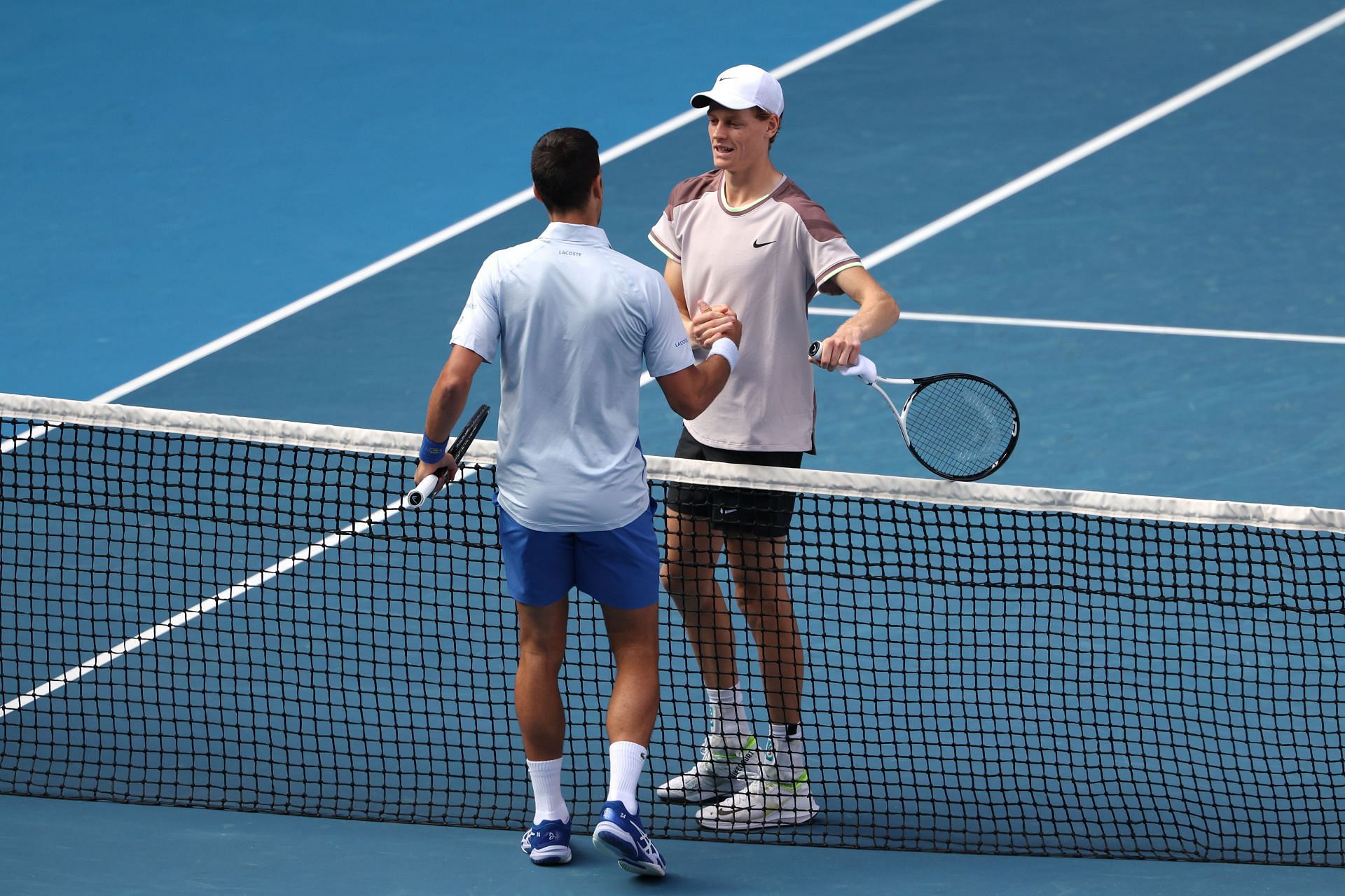 Djokovic greets Sinner at the net at the 2024 Australian Open