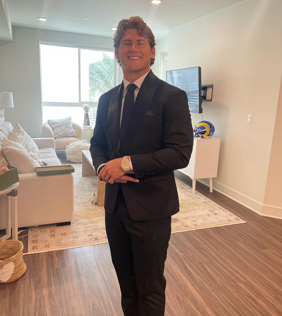 Jake Funk posing in a suit and stylish watch