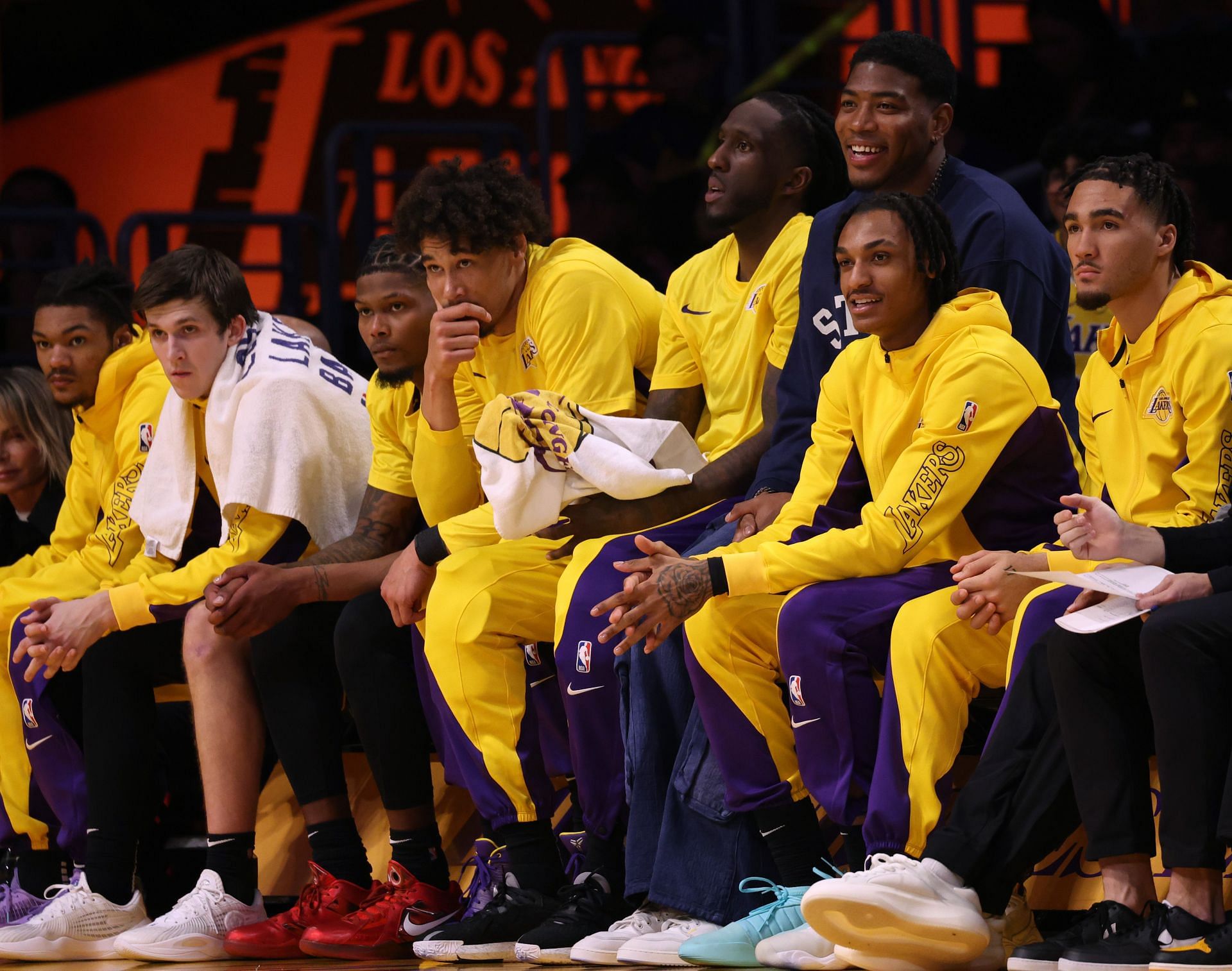 LA Lakers players watching a game from the bench