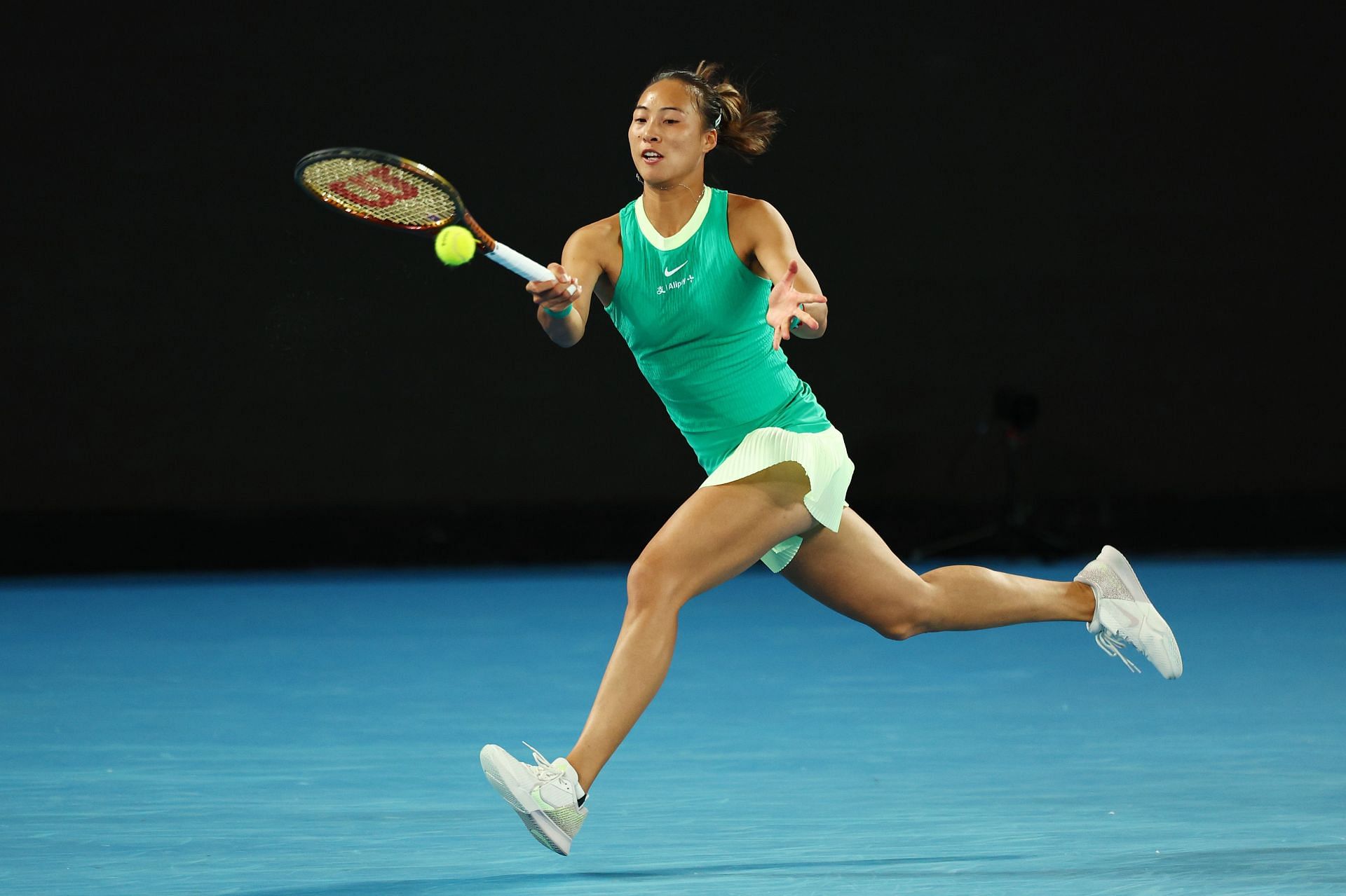 Zheng Qinwen strikes the ball at the 2024 Australian Open.