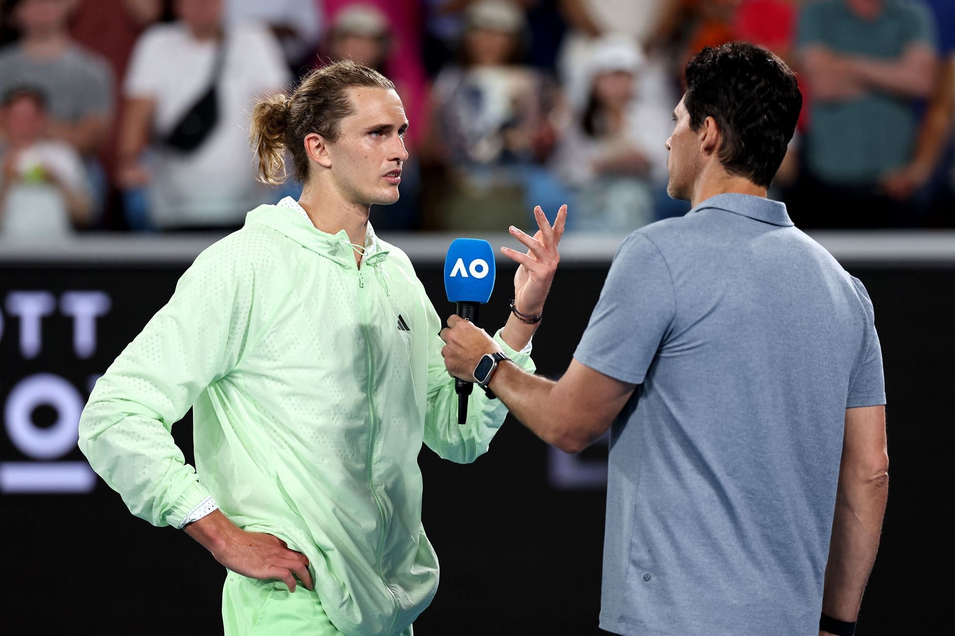 Alexander Zverev (L) gives on-court interview following his first-round win in Melbourne.