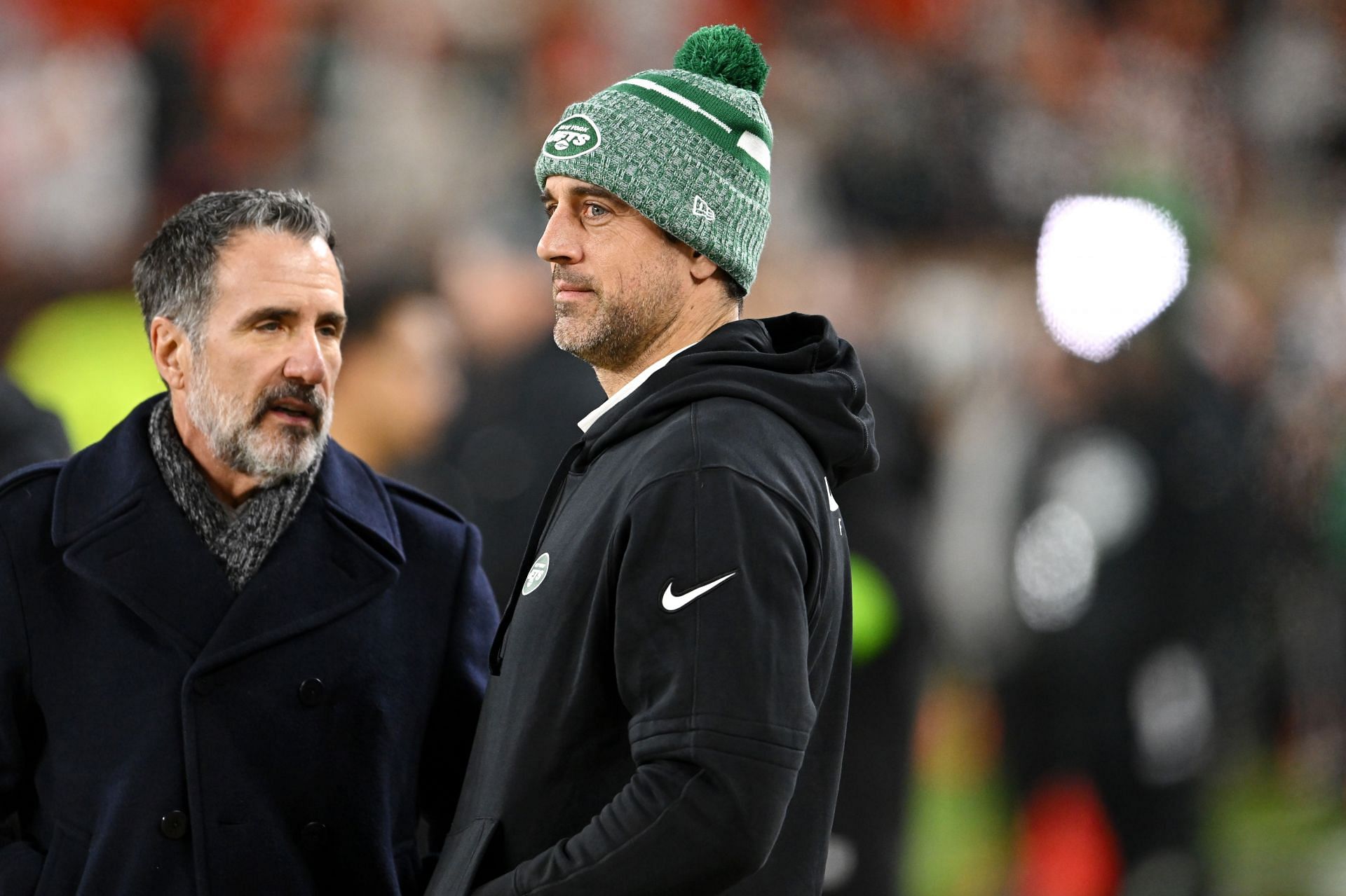 Aaron Rodgers (right) says that he will return in 2024.