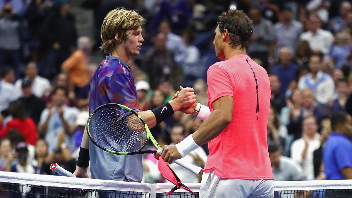 Rafael Nadal (R) and Andrey Rublev greet each other at the net following their 2017 US Open match