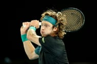 Andrey Rublev plays a backhand against Alex de Minaur