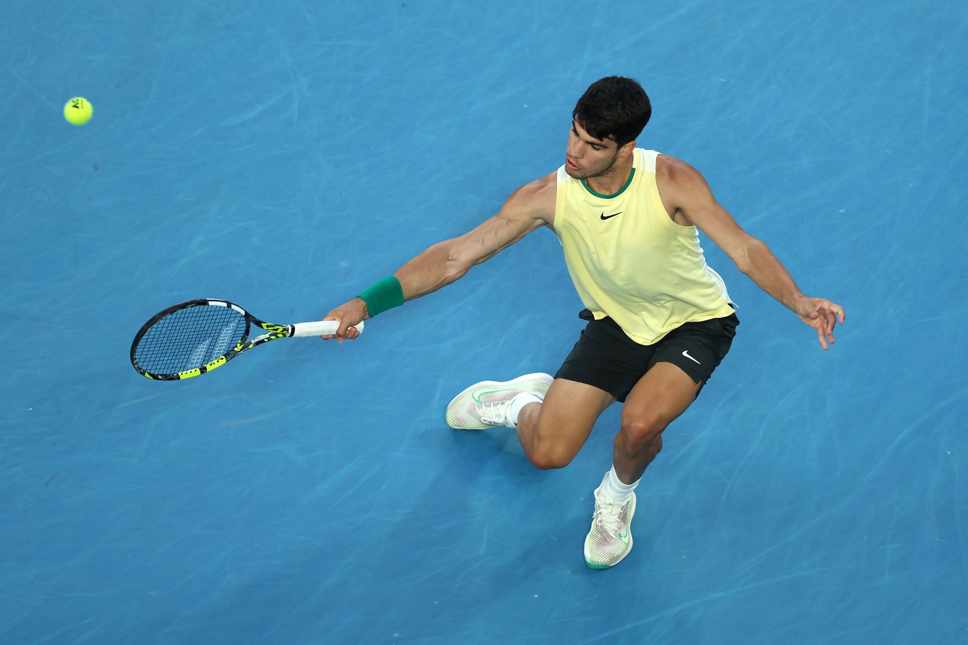 Carlos Alcaraz returns a ball at the 2024 Australian Open