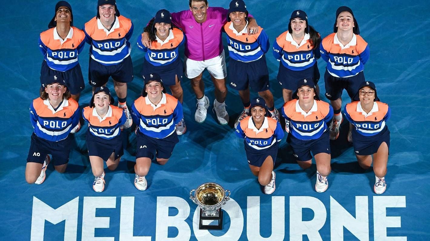 2022 champion Rafael Nadal poses with ball kids wearing Ralph Lauren outfits