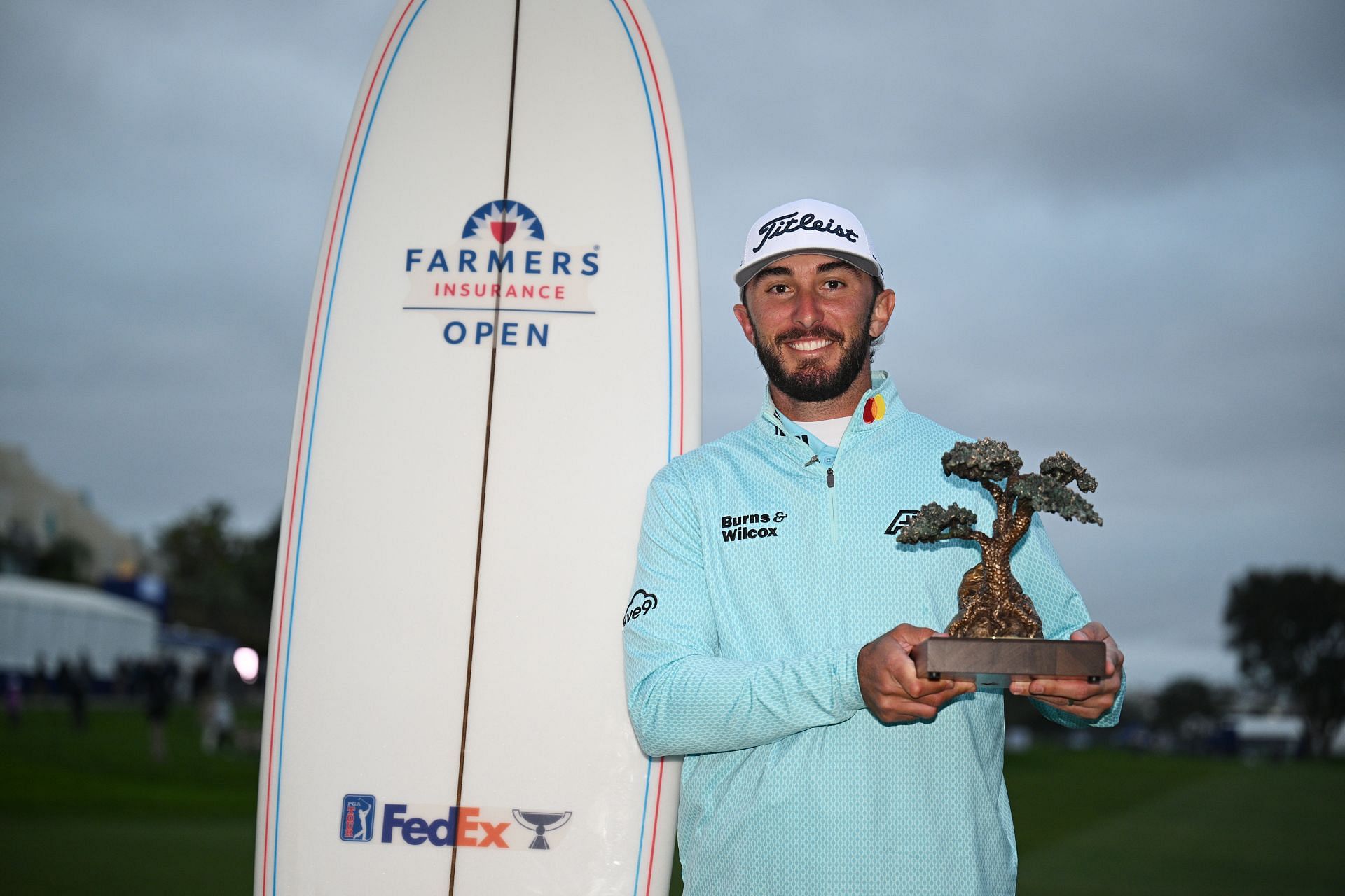 Max Homa celebrates with the trophy after winning the Farmers Insurance Open 2023