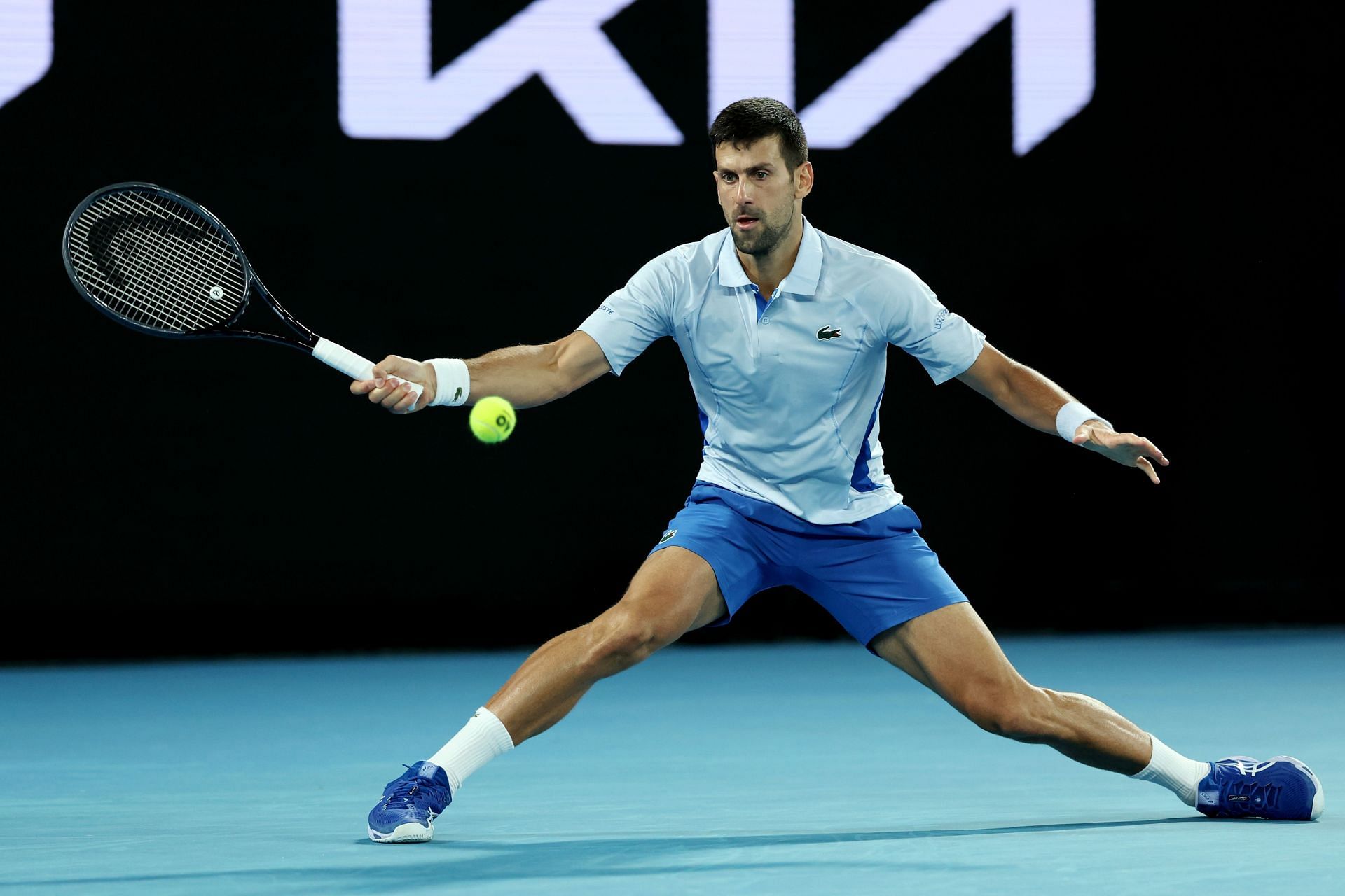 Novak Djokovic retrieves a ball at Australian Open 2024