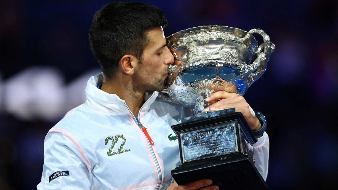 Novak Djokovic poses with the 2023 Australian Open trophy