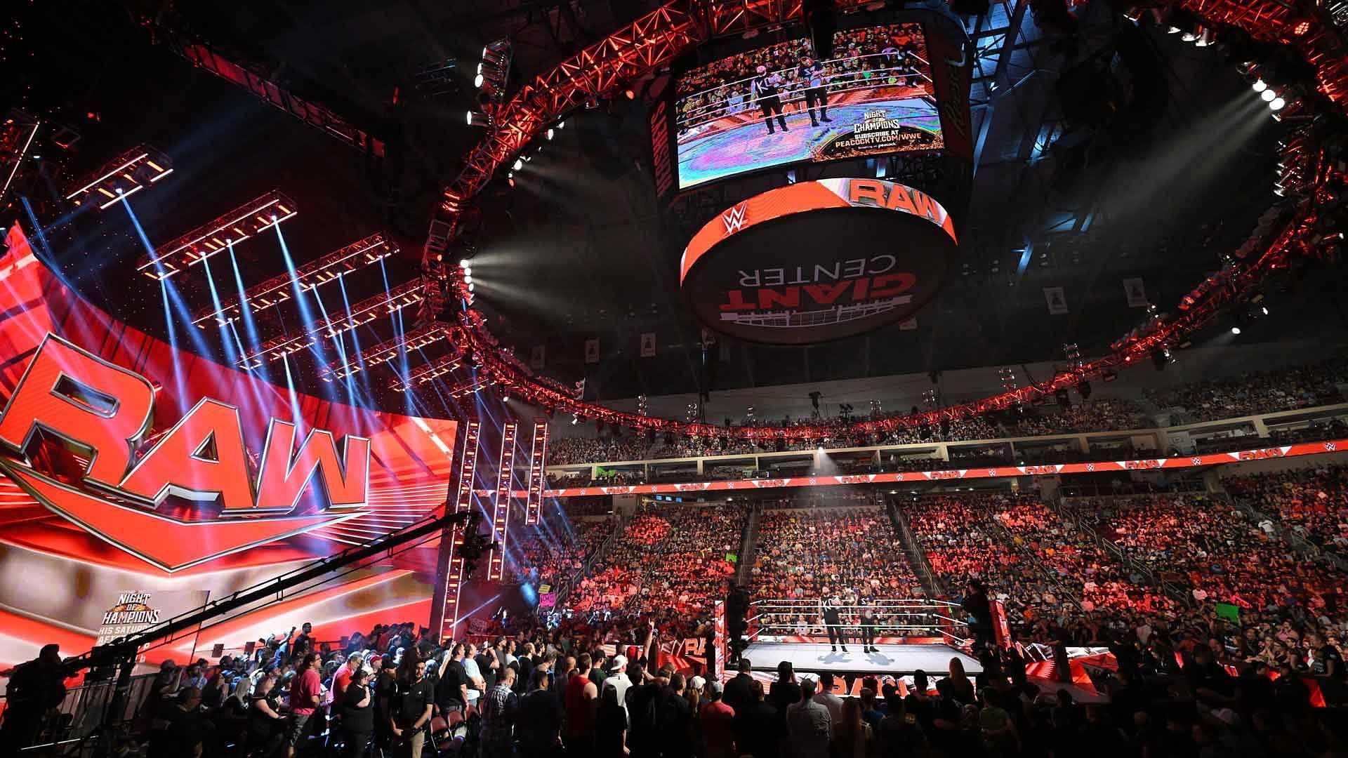 The WWE RAW ring and stage/set on display inside a packed arena