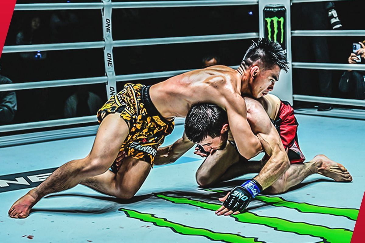 Joshua Pacio locks down Mansur Malachiev during their strawweight MMA match. 