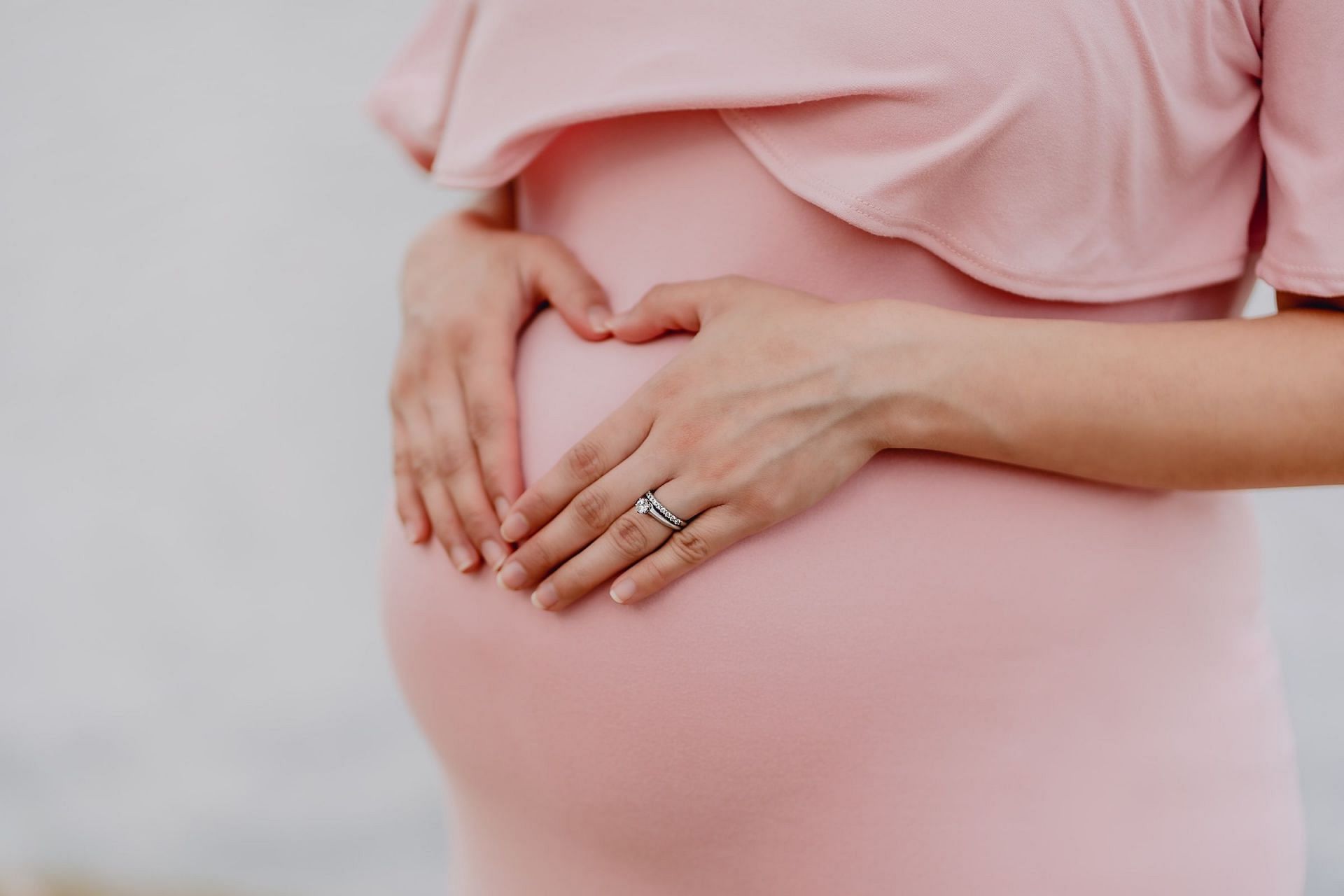 Lifting weights during pregnancy (Image via Unsplash/Juan Encalada)