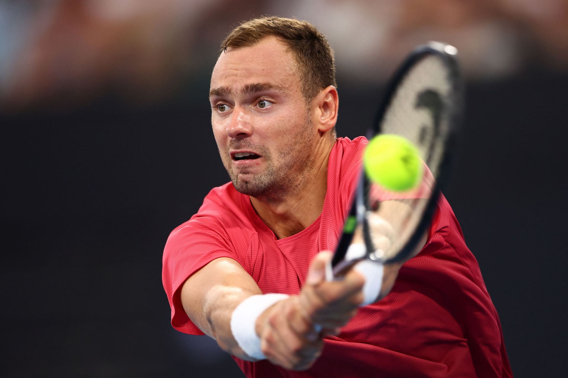 Roman Safiullin hits a backhand at the 2024 Brisbane International