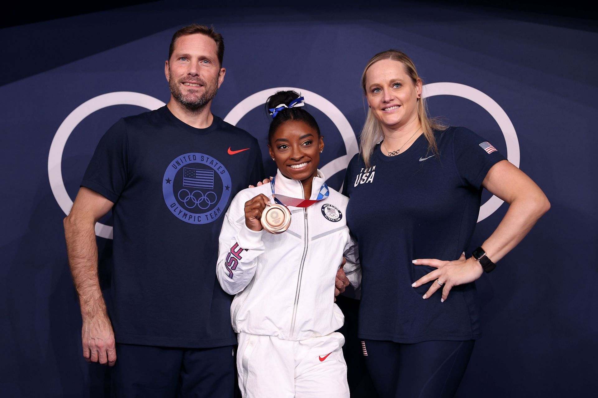 Simone Biles of Team United States poses with the bronze medal alongside coaches Laurent Landi and Cecile Canqueteau-Landi following the Women&#039;s Balance Beam Final at the 2020 Olympic Games in Tokyo, Japan Gymnastics.