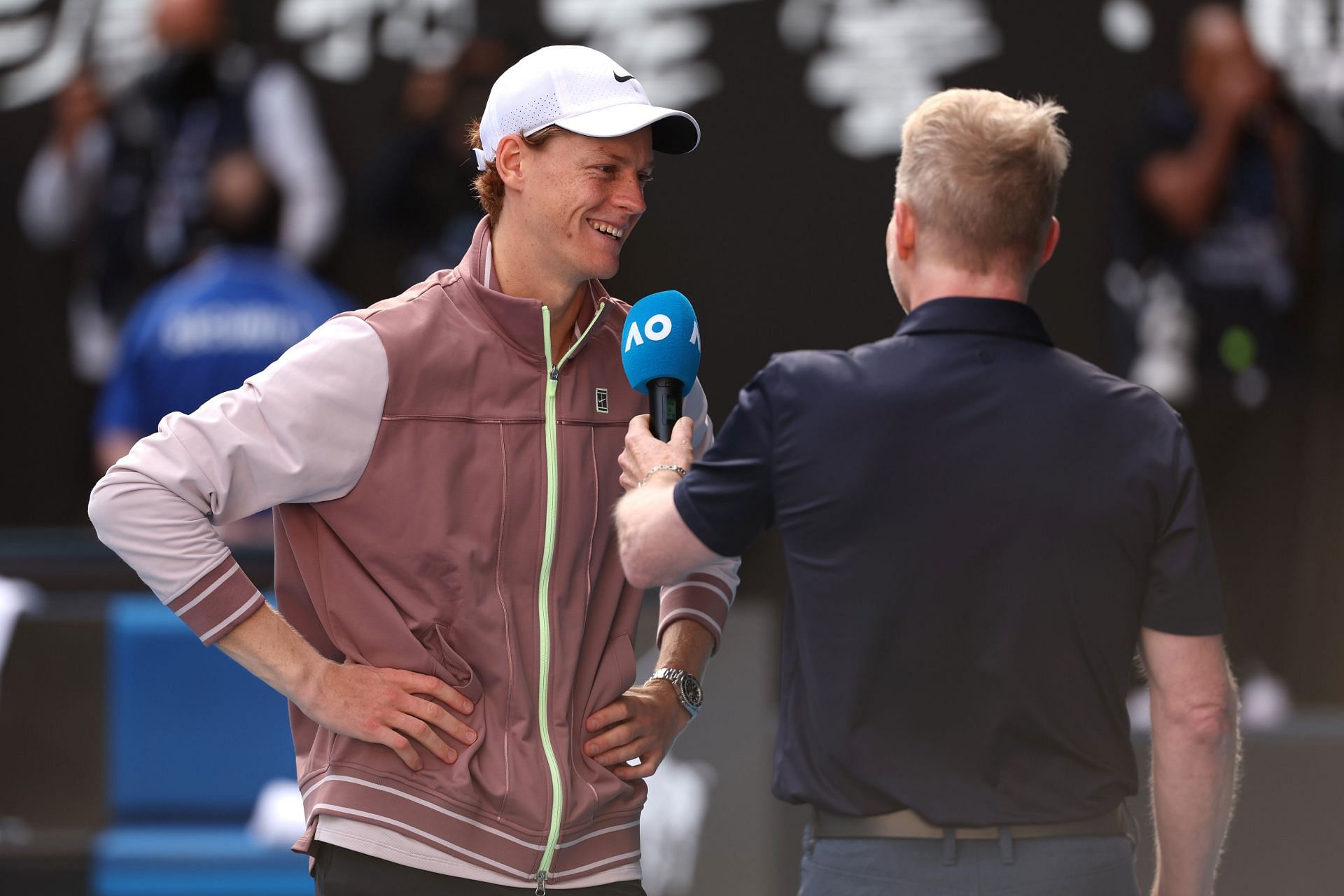 Jannik Sinner speaks to Jim Courier after defeating Novak Djokovic at the 2024 Australian Open.