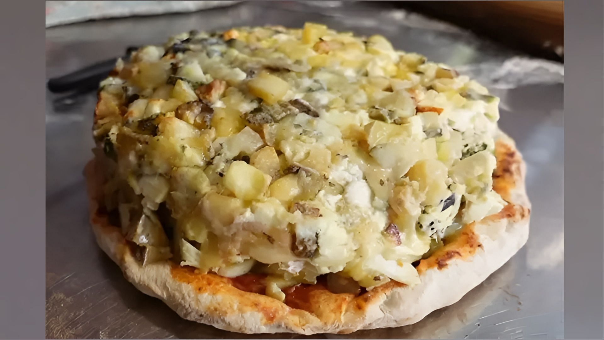 The record-shattering pizza is topped with over 1,001 cheese varieties (Image via Guinness World Records)