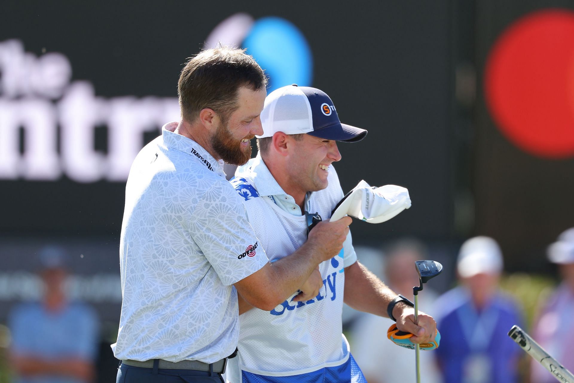 Chris Kirk (L) celebrates with caddie Michael Cromie (R) after winning the Sentry