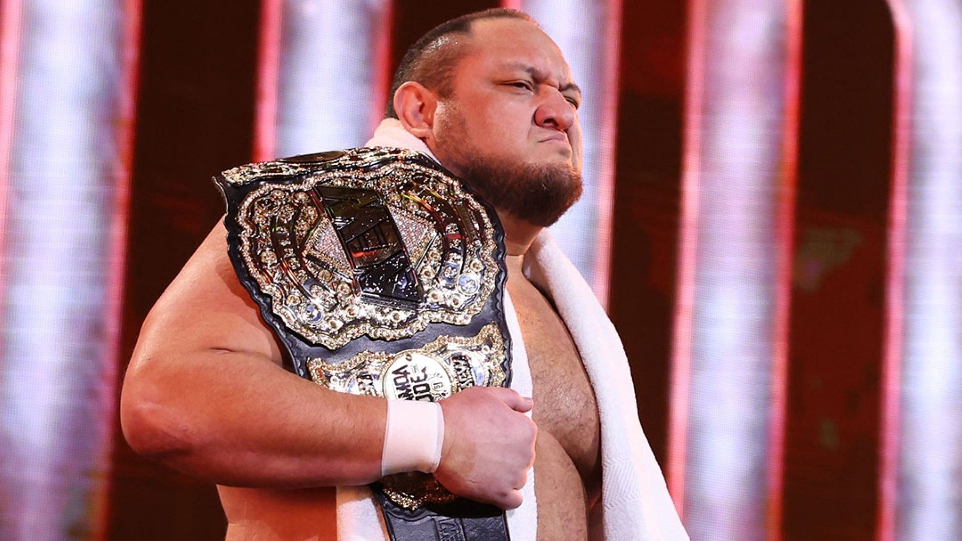 Samoa Joe heads to the ring with the AEW World Championship