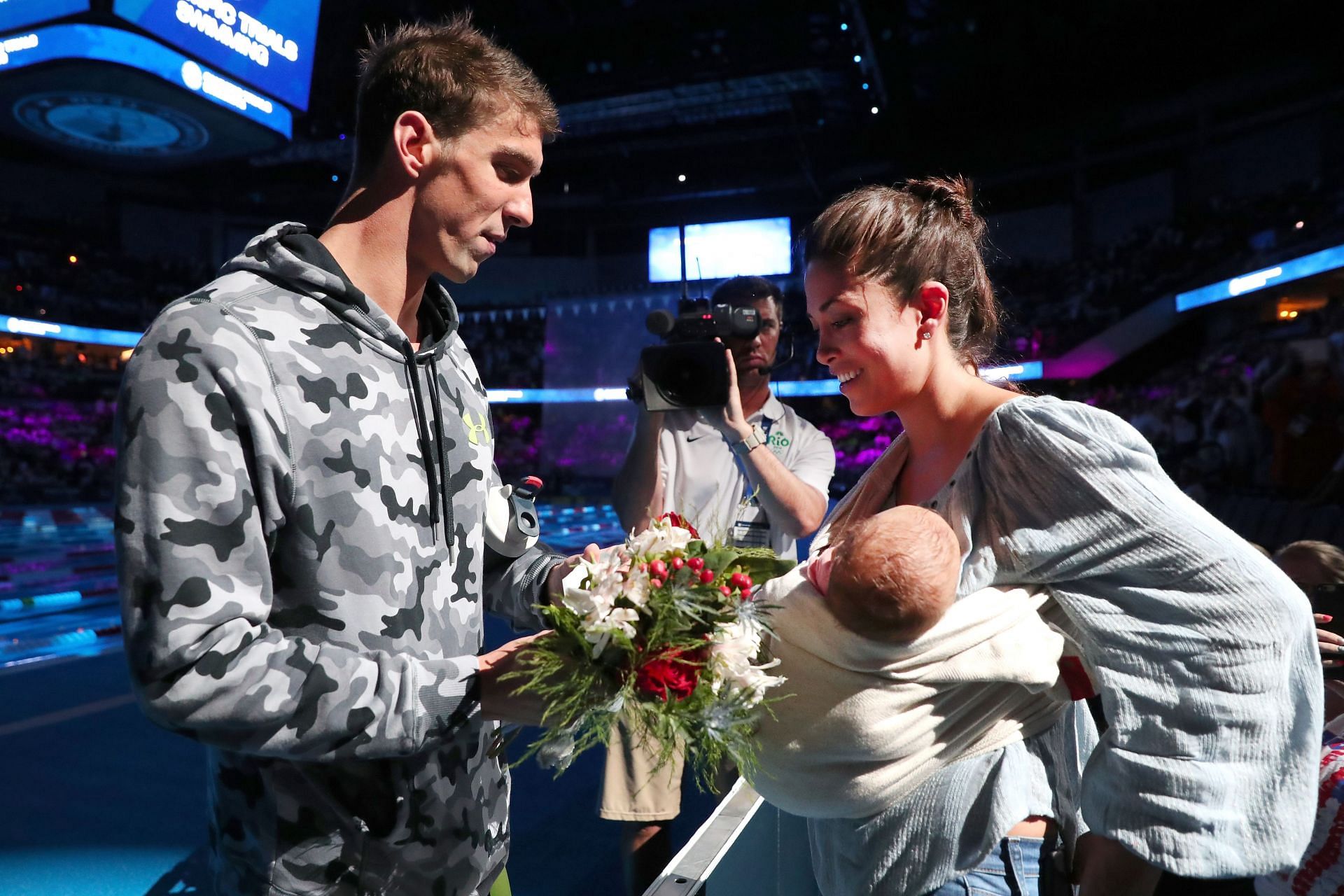 Michael Phelps celebrates with his wife Nicole Johnson and their son Boomer after finishing first in the final heat for the Men&#039;s 200-meter Individual Medley at the 2016 c Team Swimming Trials in Omaha, Nebraska.