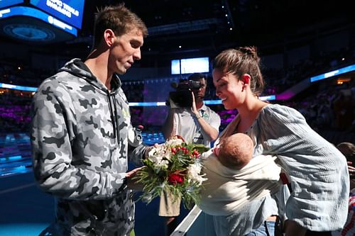 Michael Phelps celebrates with his wife Nicole Johnson and their son Boomer after finishing first in the final heat for the Men's 200-meter Individual Medley at the 2016 c Team Swimming Trials in Omaha, Nebraska.