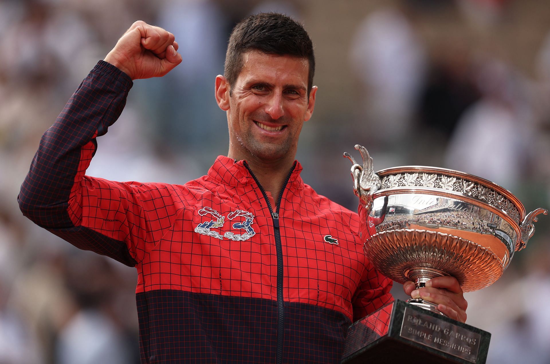 Novak Djokovic poses with the 2023 French Open trophy.