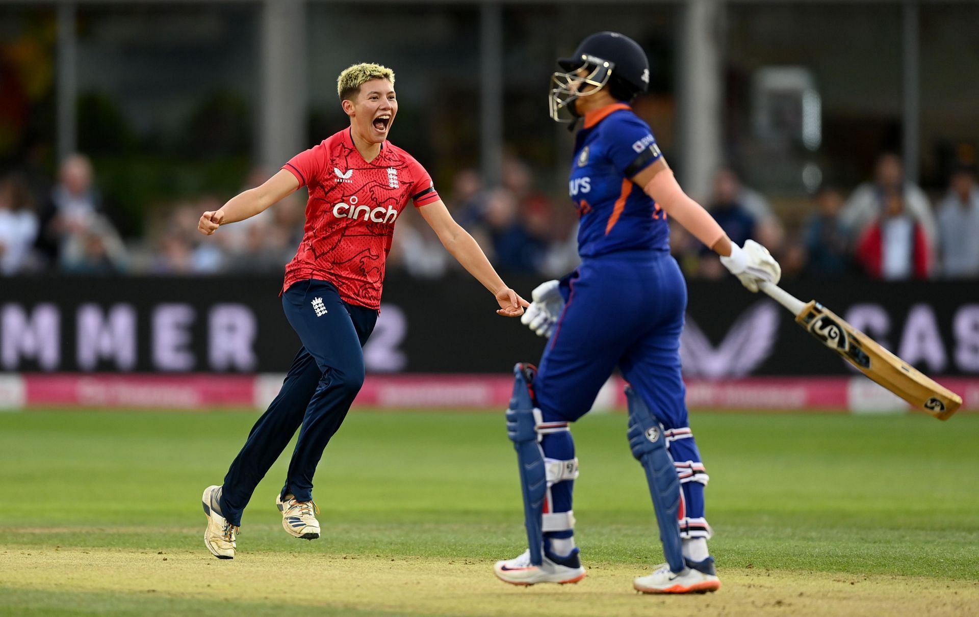 Issy Wong (left) celebrating the wicket of Shefali Varma in a T20I in 2022.