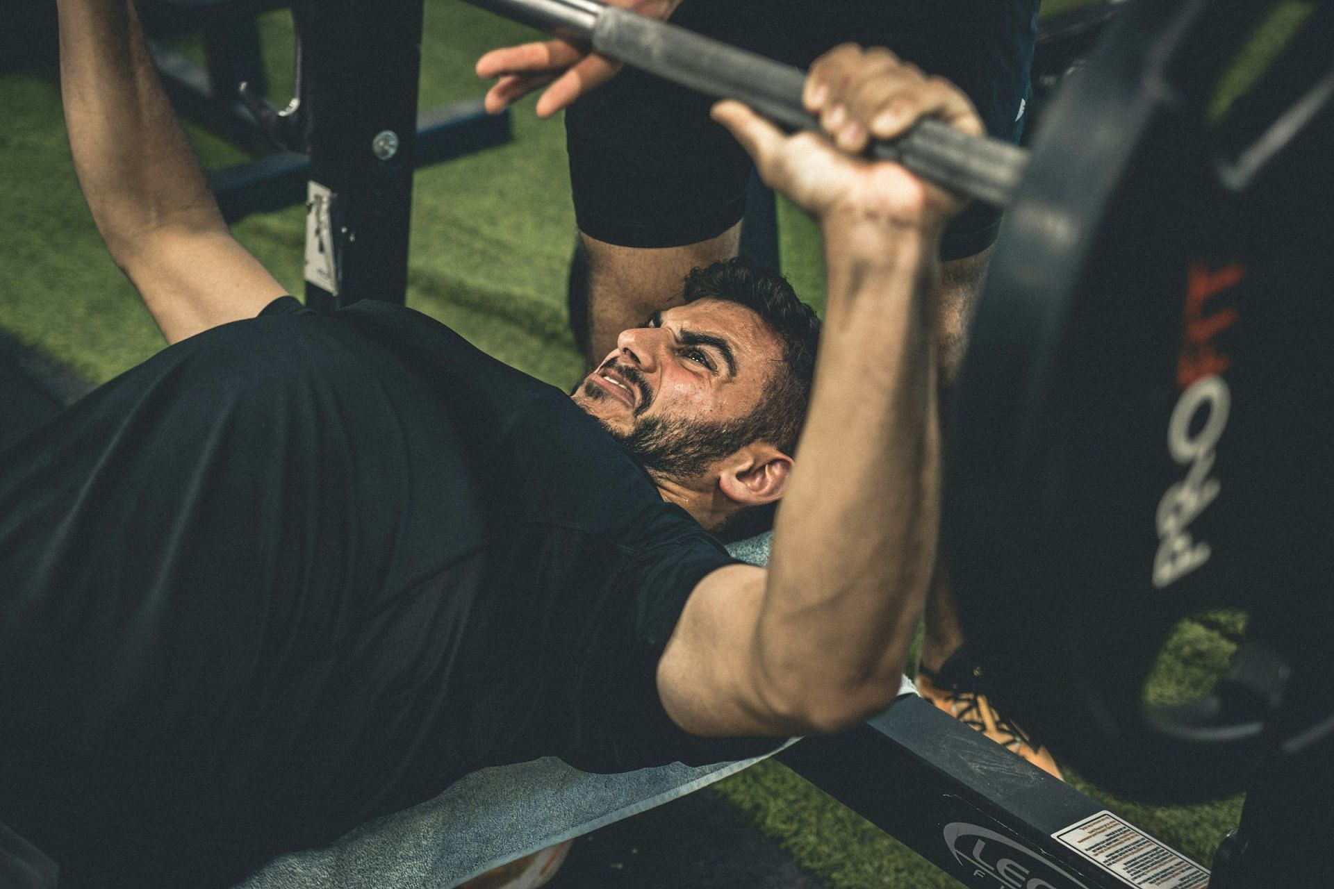 Suicide grip bench press (Image via Unsplash/Shoham Avisur)