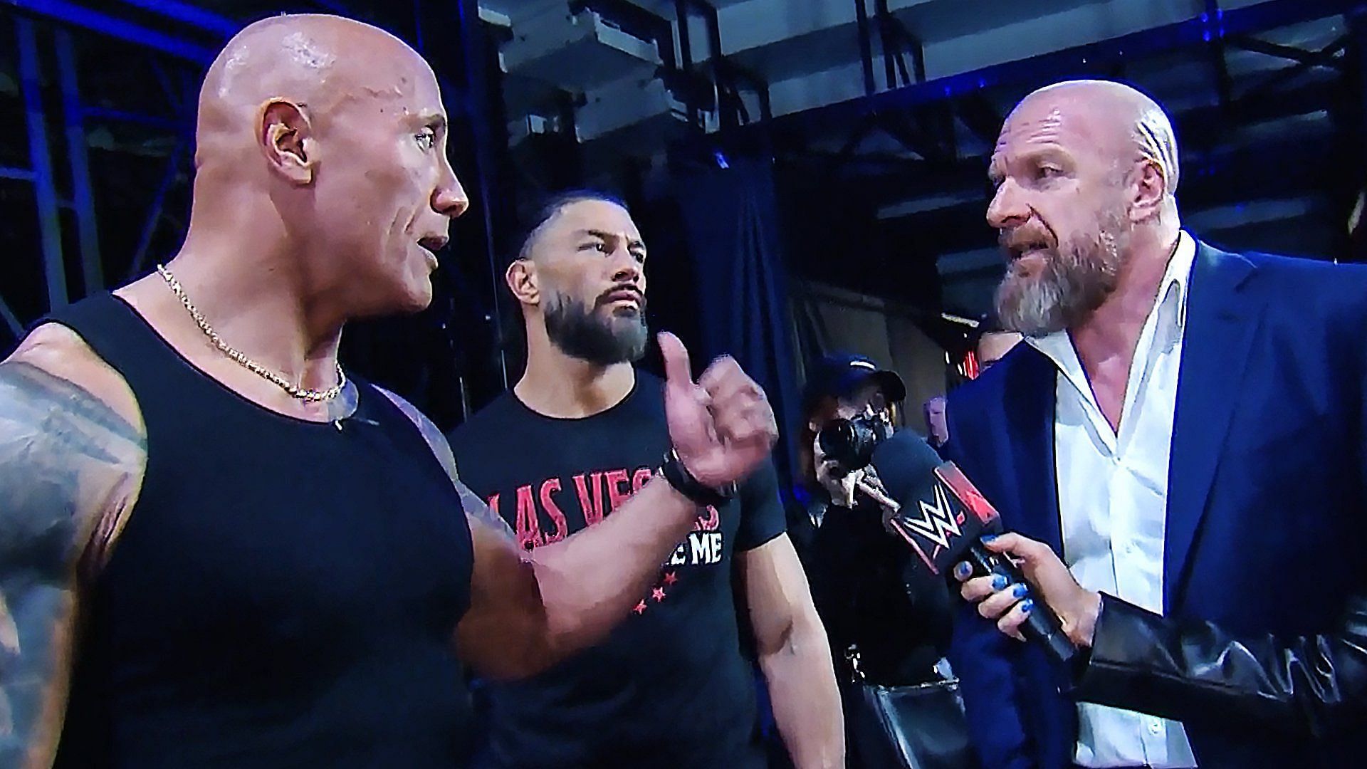 The Rock and Roman Reigns in a segment with Triple H
