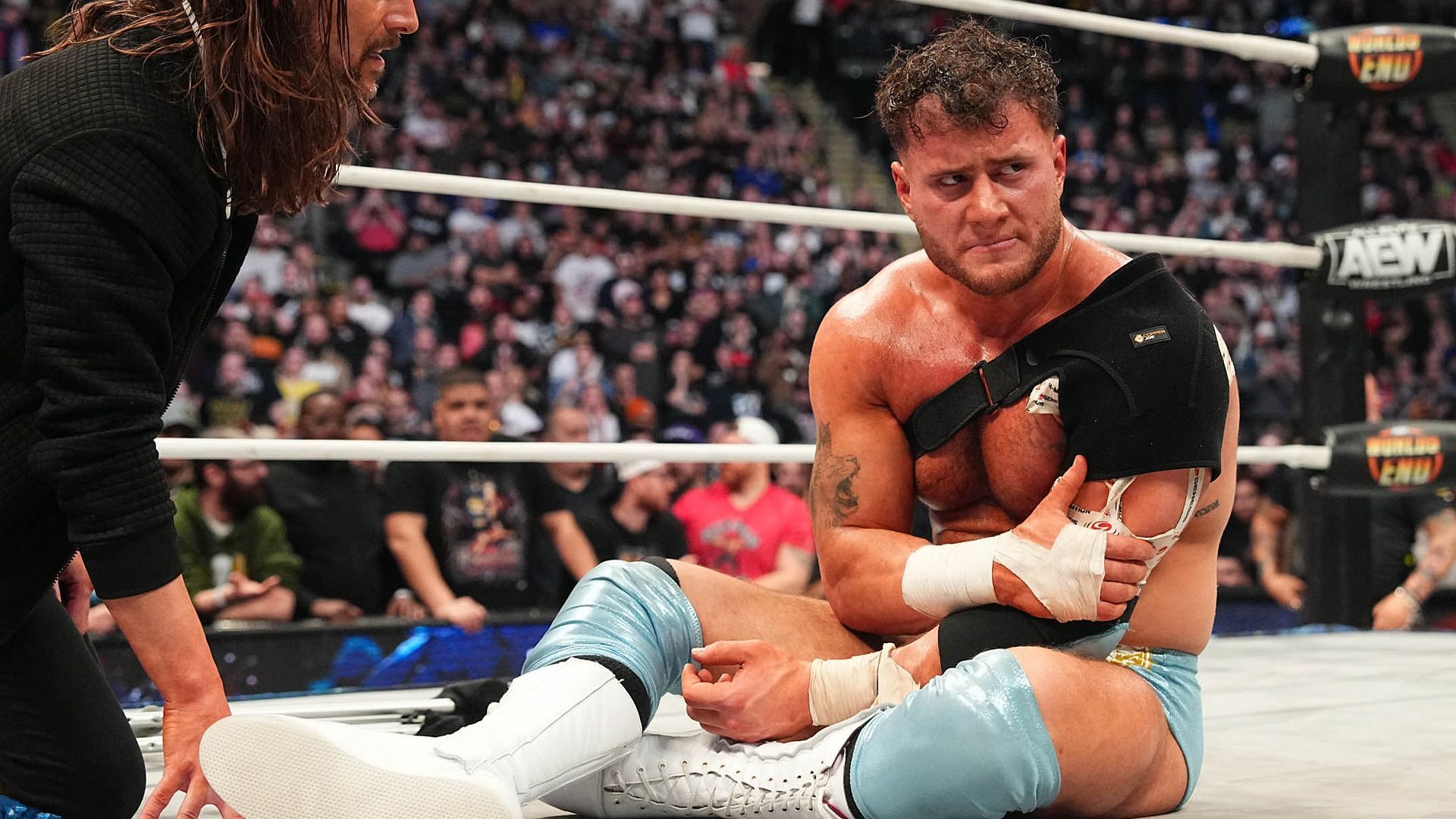 MJF nurses his injured shoulder after losing his title to Samoa Joe at AEW Worlds End