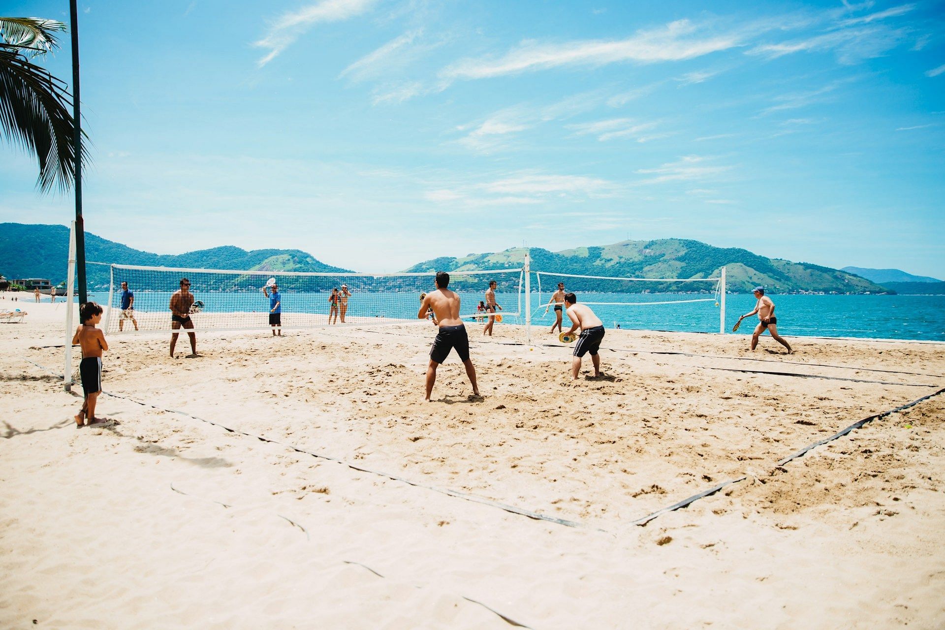 A representative image of beach volleyball is used. (Image via Unsplash)