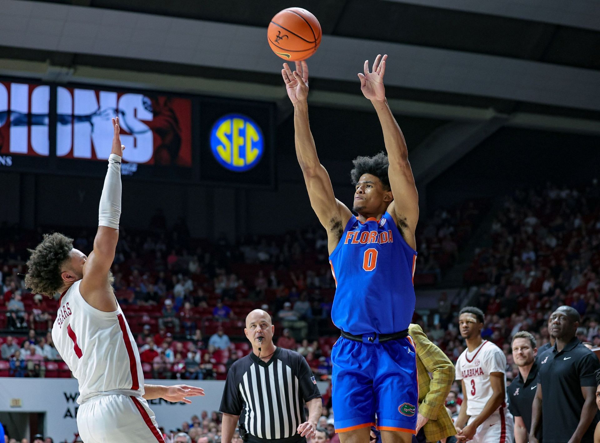 Zyon Pullin #0 of the Florida Gators puts up a first-half 3 over Mark Sears #1 of the Alabama Crimson Tide.