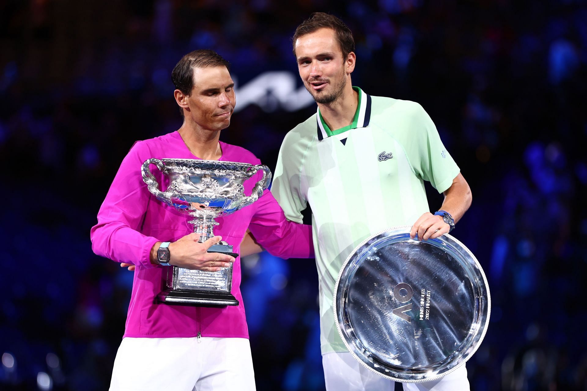 Rafael Nadal (L) and Daniil Medvedev pictured with their 2022 Australian Open trophies