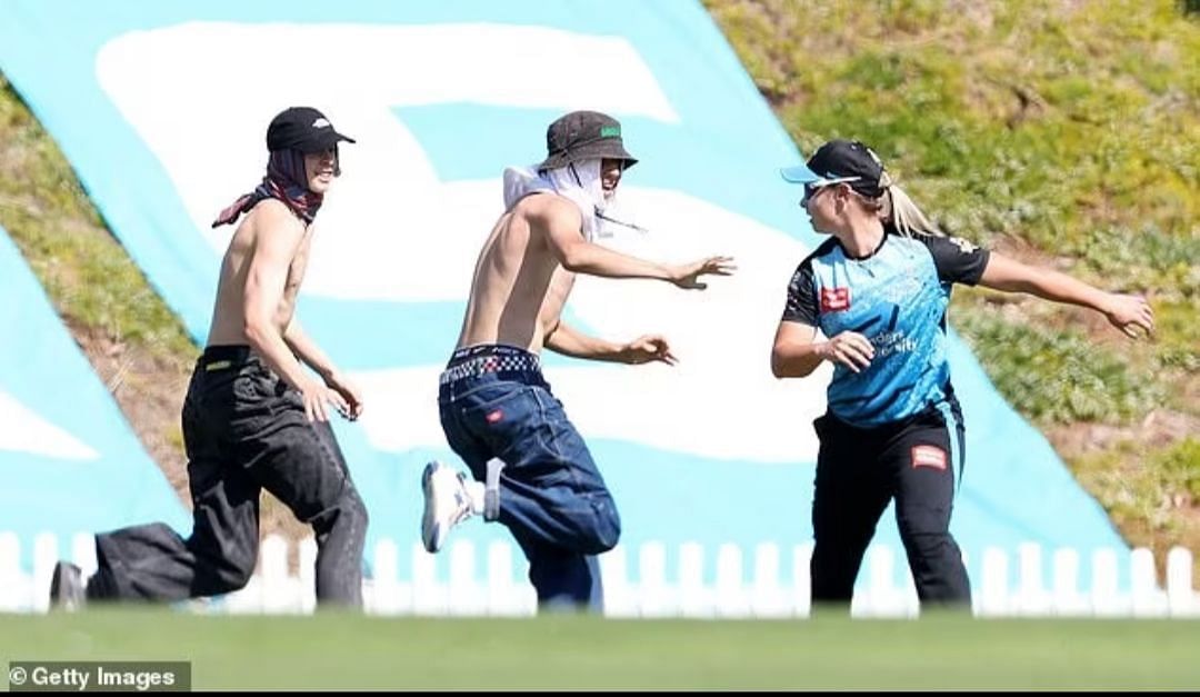 Two masked men invade a women's Big Bash League game