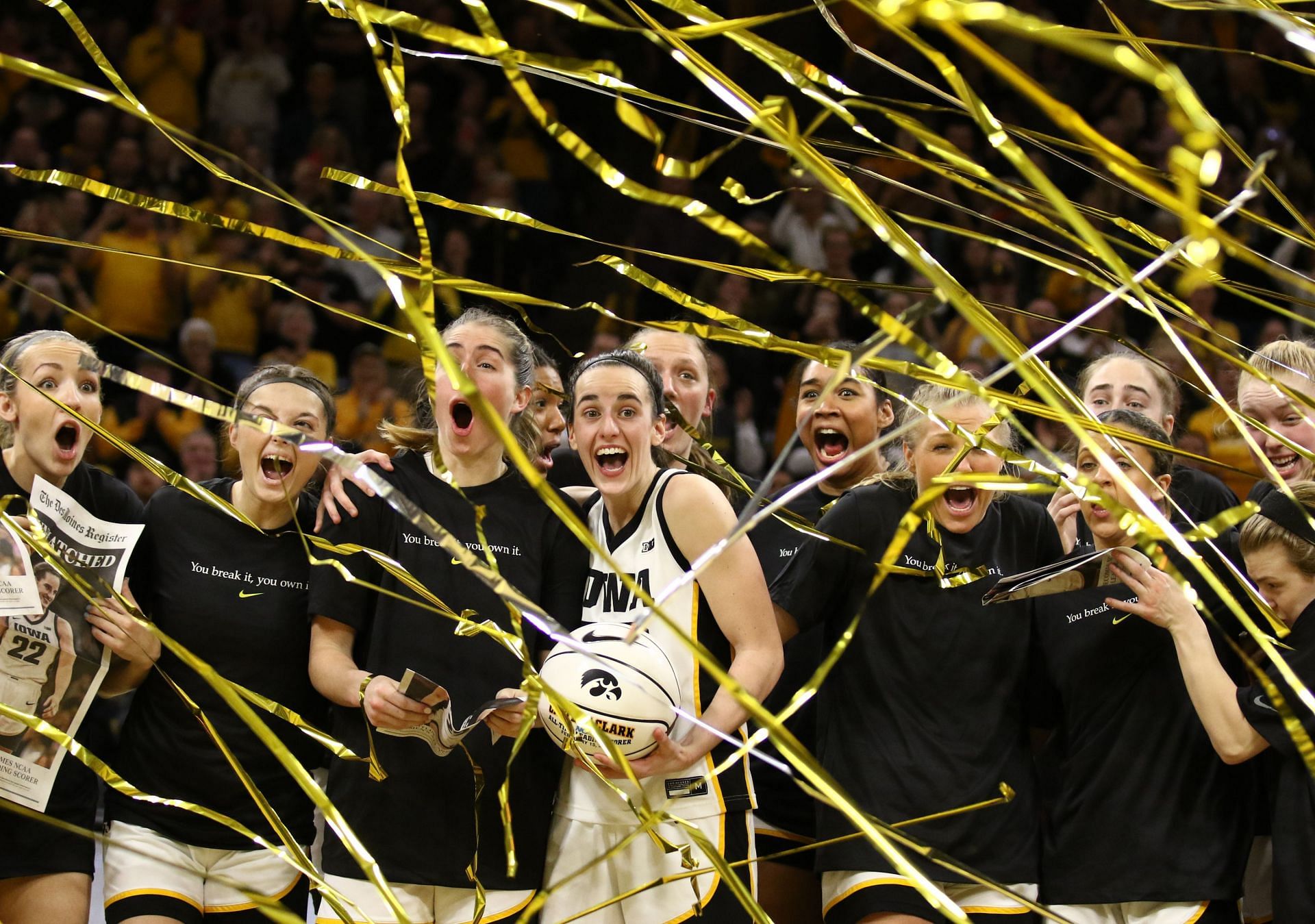 Guard Caitlin Clark #22 of the Iowa Hawkeyes celebrates with teammates during a presentation after breaking the NCAA women&#039;s all-time scoring record during the game against the Michigan Wolverines.