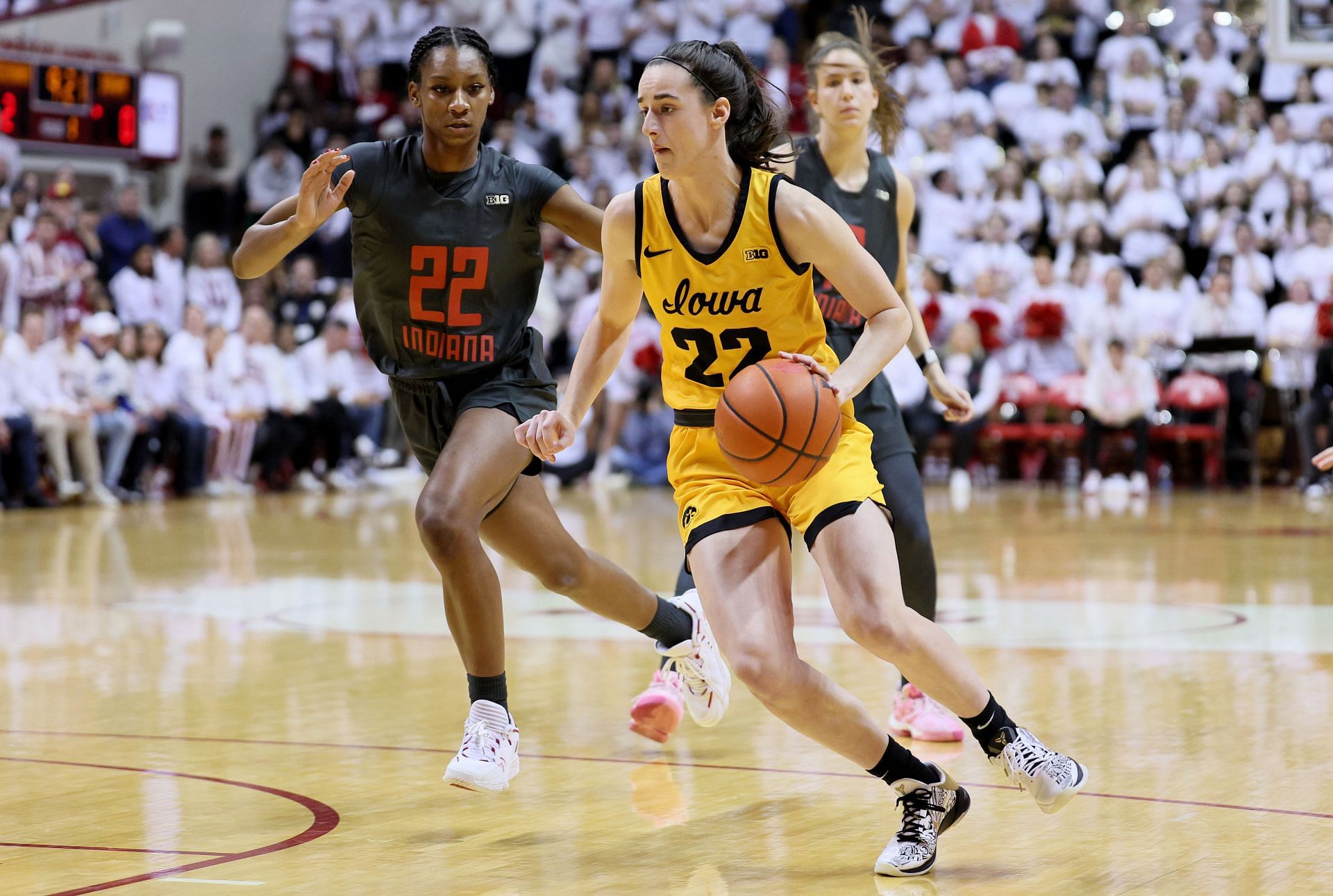 Caitlin Clark of the Iowa Hawkeyes is defended by Chloe Moore-McNeil of the Indiana Hoosiers.