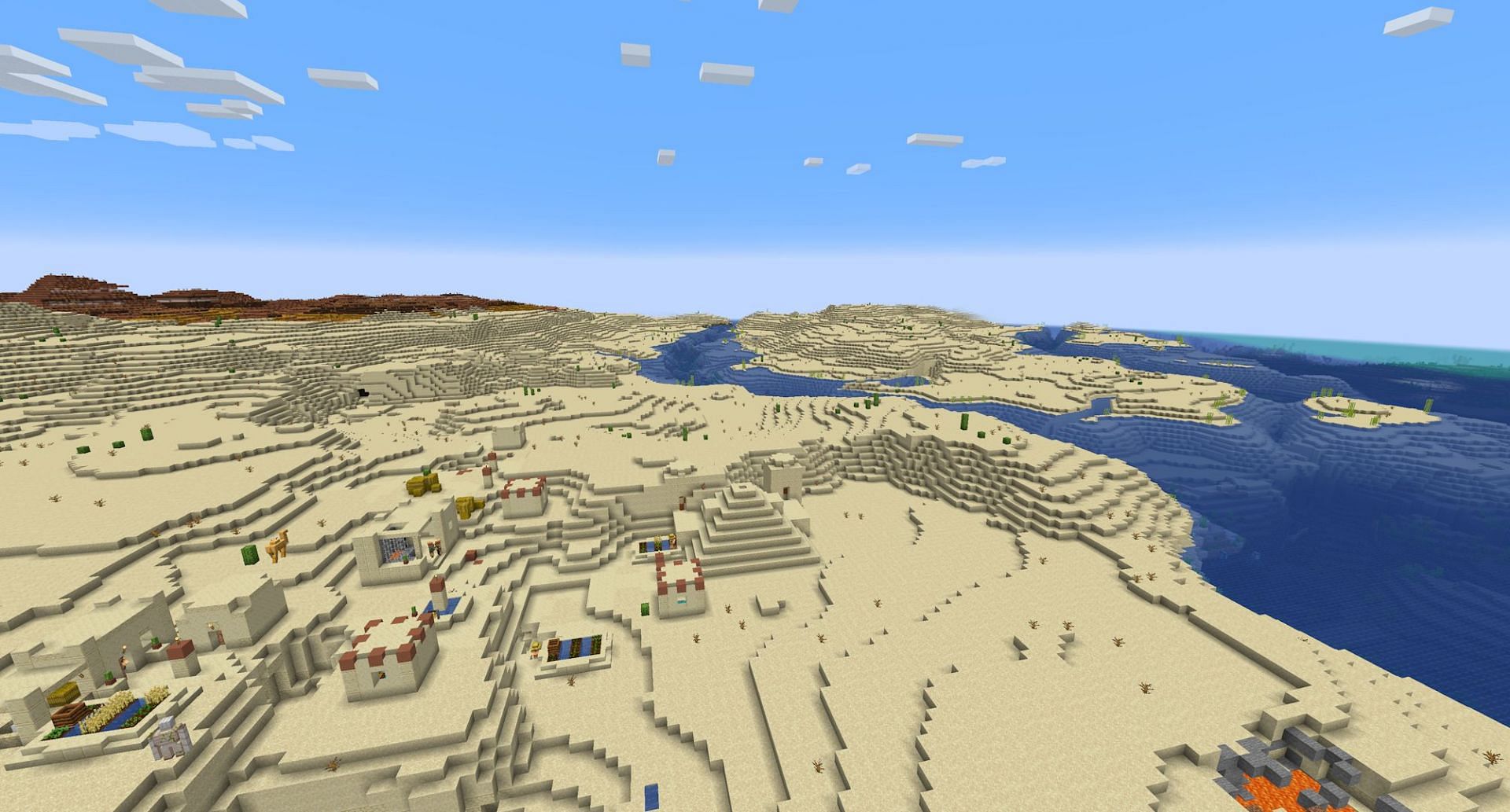 A desert temple and village, with backing warm ocean and badlands (Image via Mojang Studios)