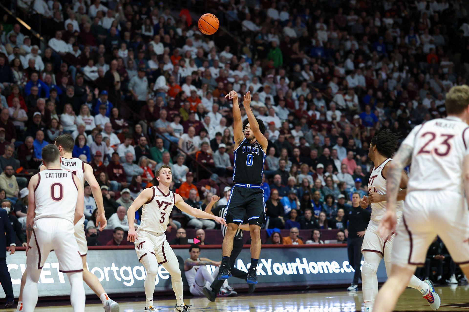 Jared McCain #0 of the Duke Blue Devils shoots over Sean Pedulla #3 of the Virginia Tech Hokies in the first half during a game at Cassell Coliseum in Blacksburg, Virginia.