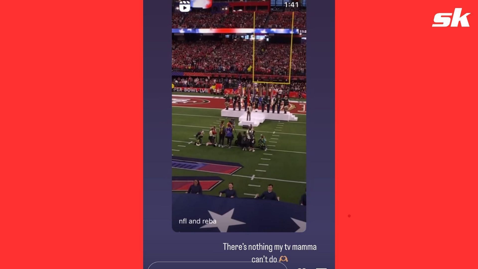 JoAnna Garcia cheers on Reba McEntire from the crowd during the latter's performance of the U.S.A. National Anthem.