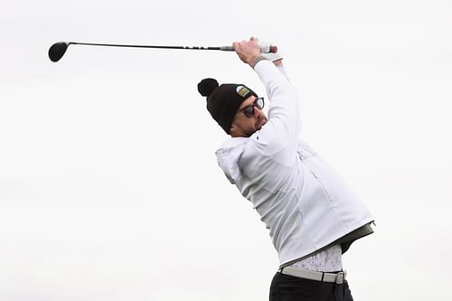 Michael Phelps plays a tee shot on the first hole during the Pro-am to the WM Phoenix Open at TPC Scottsdale in Arizona.