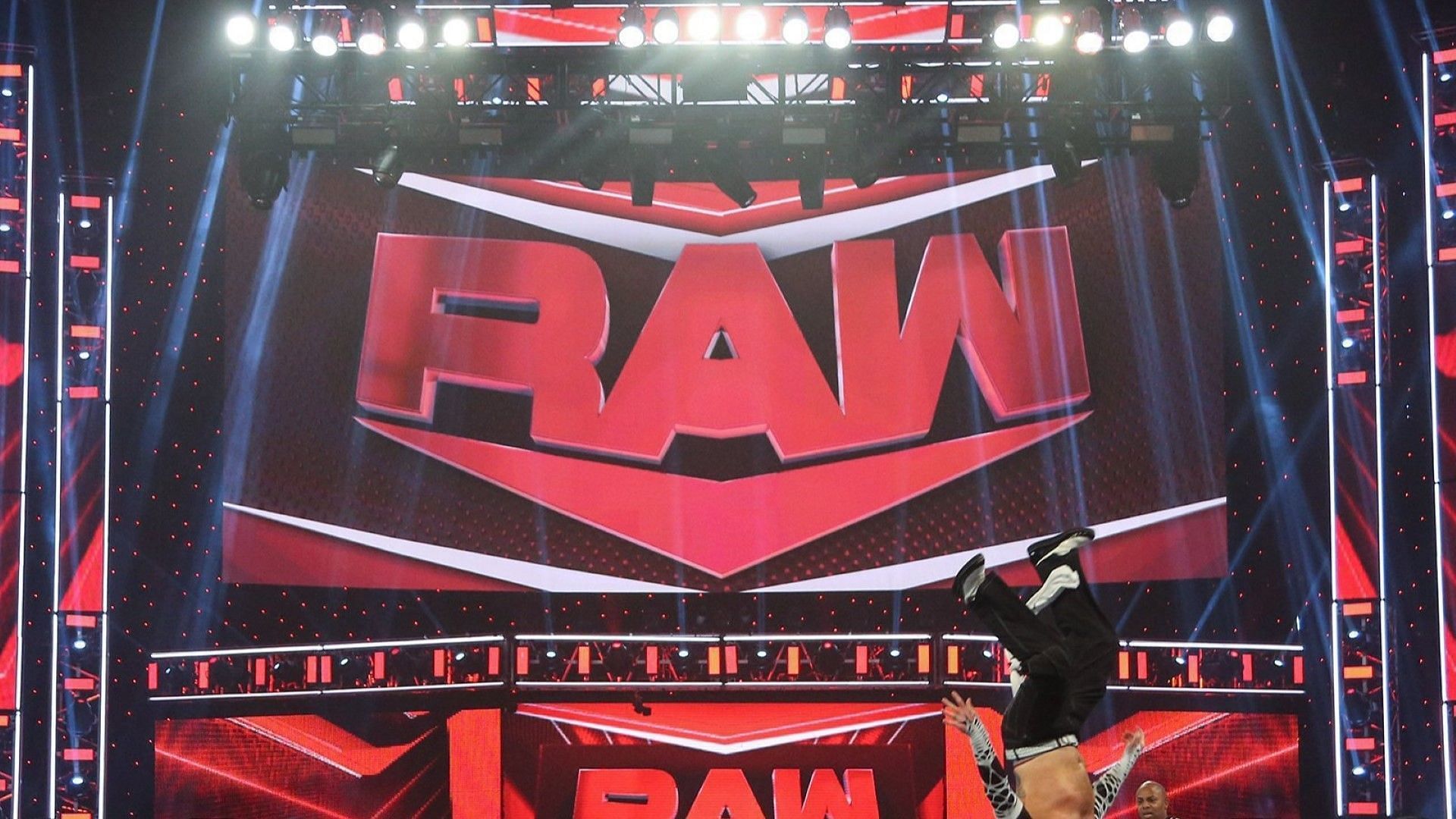 The WWE RAW logo on display via the stage inside of a packed arena