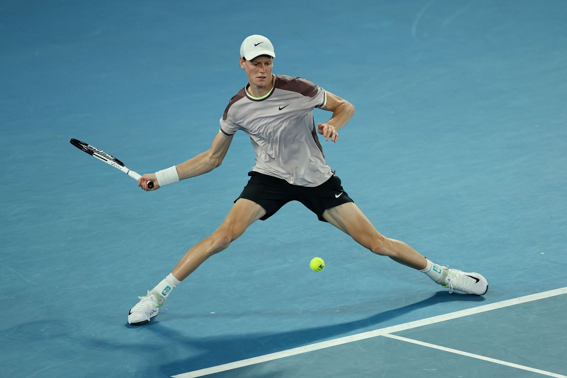 Jannik Sinner returns a ball at the 2024 Australian Open