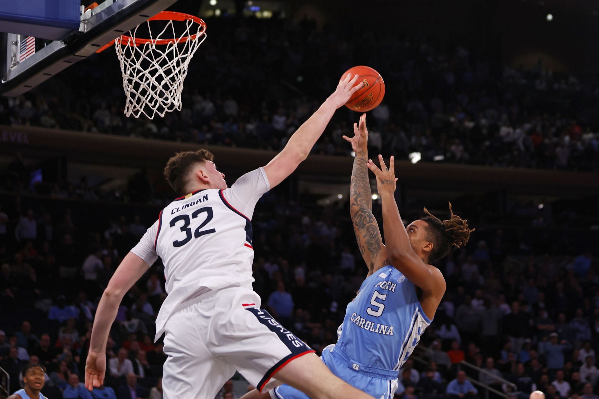 Donovan Clingan #32 of the Connecticut Huskies blocks a shot from Armando Bacot #5 of the North Carolina Tar Heels.