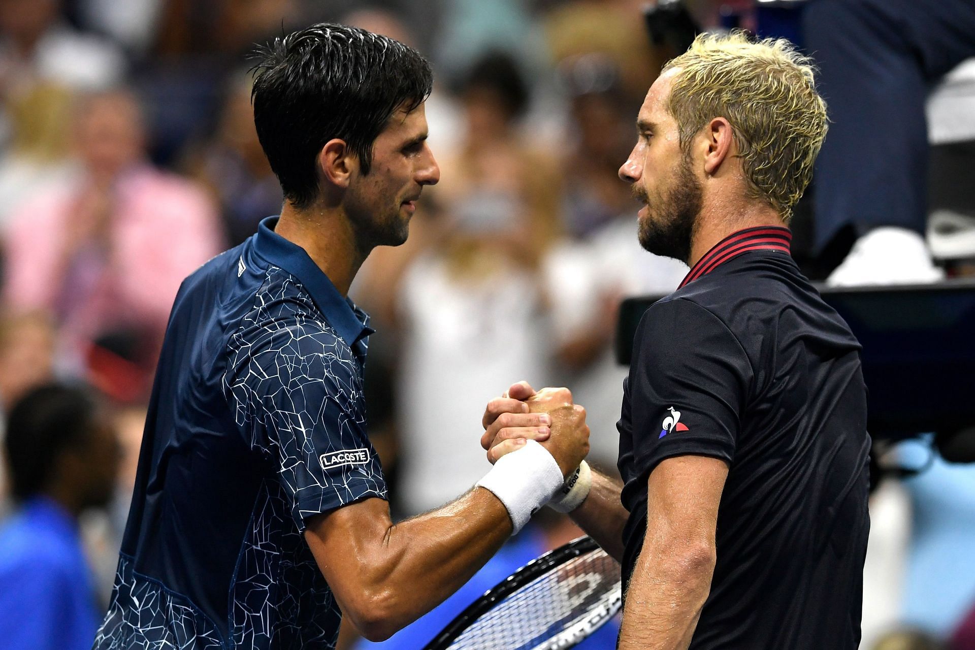 Novak Djokovic (L) and Richard Gasquet greet each other at 2018 US Open.